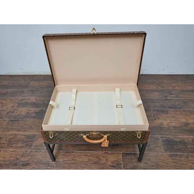 A vintage Louis Vuitton trunk from the late 1970s to early 1980s finds new life as a distinctive coffee table, seamlessly...