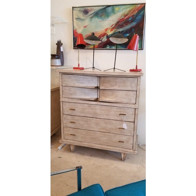 Dims.: 41"W x 19.75"D x 45"H Highboy in whitewash finish with brass accents. It consists of three bottom drawers and a...