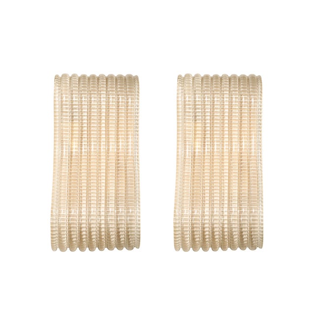 A stunning pair of contemporary Italian sconces, hand-blown with exquisite attention to detail, showcasing a seamless...