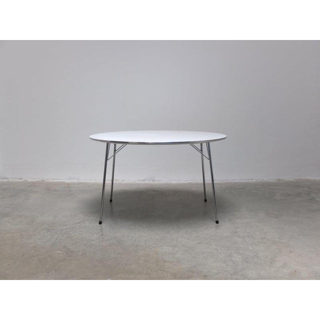 Rare model ‘3600’ dining table designed by Arne Jacobsen around 1960. This example features a round white laminated top...