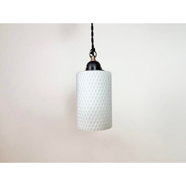 Vintage milk glass ceiling light made in former Czechoslovakia during the 1970s. The bakelite socket requires standard...