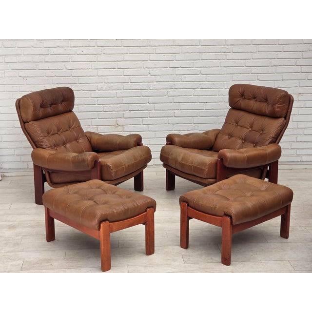 1970s, Swedish design. Armchair with footstool. Original brown furniture leather with patina, dark beech wood. Original...