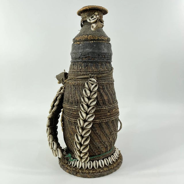This early 20th-century Ethiopian milk jug exemplifies the artistry and craftsmanship of traditional pastoral communities...