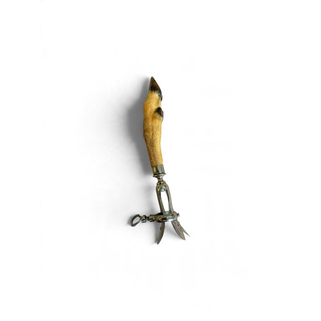 It is a carving accessory used to securely hold the bone of a roast, typically lamb, for carving. The device has an...