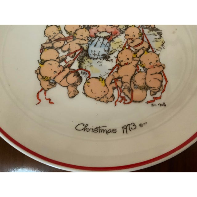 A whimsical, vintage porcelain holiday collectors plate featuring a delightful illustration by world, renowned artist and...