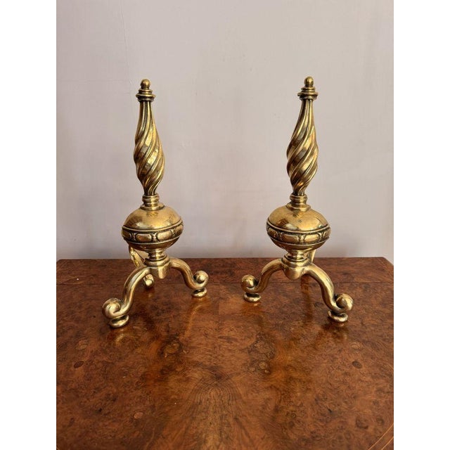Outstanding quality antique Victorian brass fire dogs, having a rope twist shape tops above a round ornate ball standing...