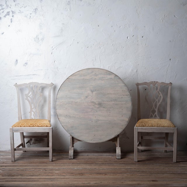 Tilting vendange table in bleached pine with round lift-top and trestle base, France, circa 1880. Circular plank top lifts...