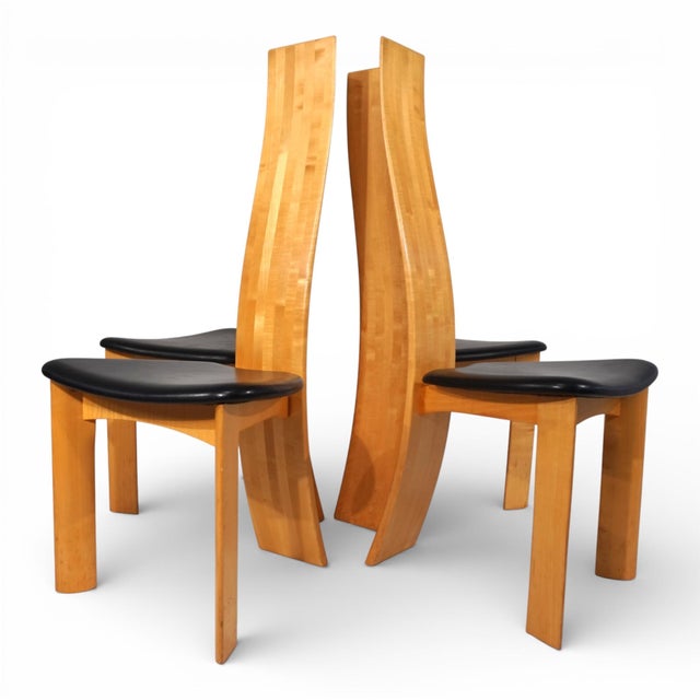 The four Iris chairs, crafted from light beechwood, are in good condition with minor signs of wear on the lower legs. The...