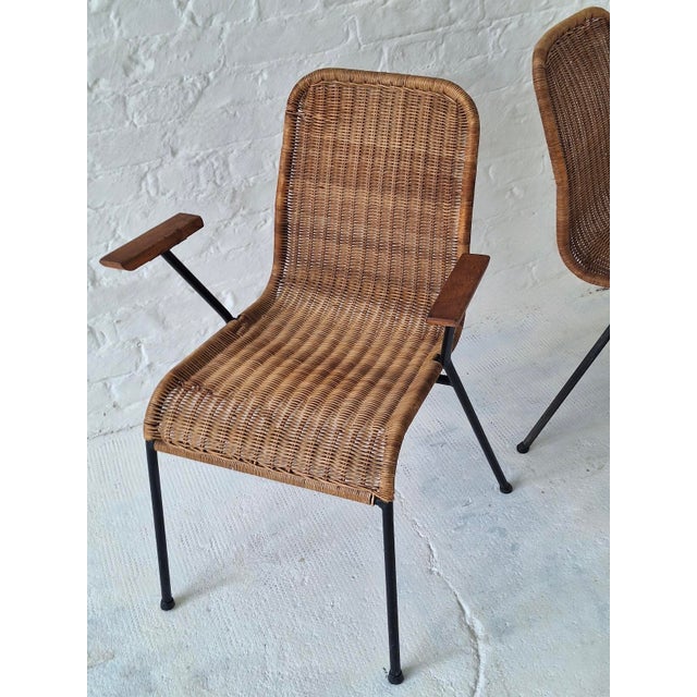 A pair of mid-century rattan dining elbow chairs on slender iron frames by Gian Franco Legler, Switzerland 1960s. I have...