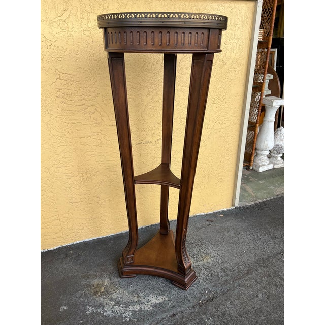 Tall mahogany pedestal table. This would make an elegant plant stand, jardiniere, or display for sculpture. The table...