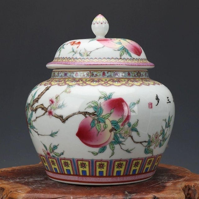 Stunning Chinese famille‑rose lidded jar decorated with abundant peaches and bats, classic symbols of longevity, fortune...