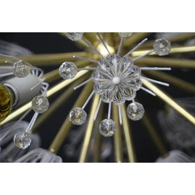 This spectacular sputnik chandelier resembles an explosion of flowers and is made up of a multitude of brass rods ending...