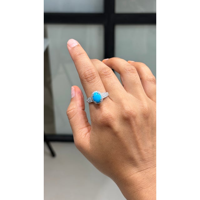 This cocktail ring showcases a 1.47 carat natural oval cabochon turquoise, set in 14k white gold. The oval cut turquoise...