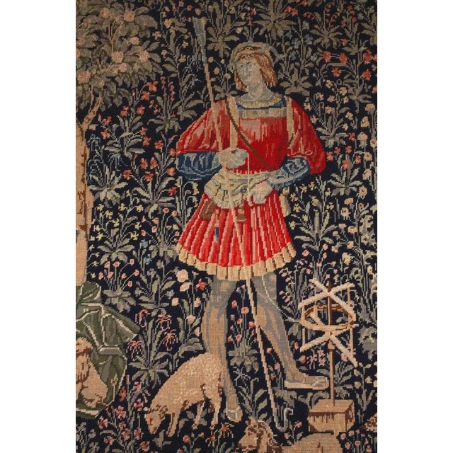 Tapestry based on French designs of thousands of flowers with a wool processing theme. Nice gilded frame. The tapestry is...