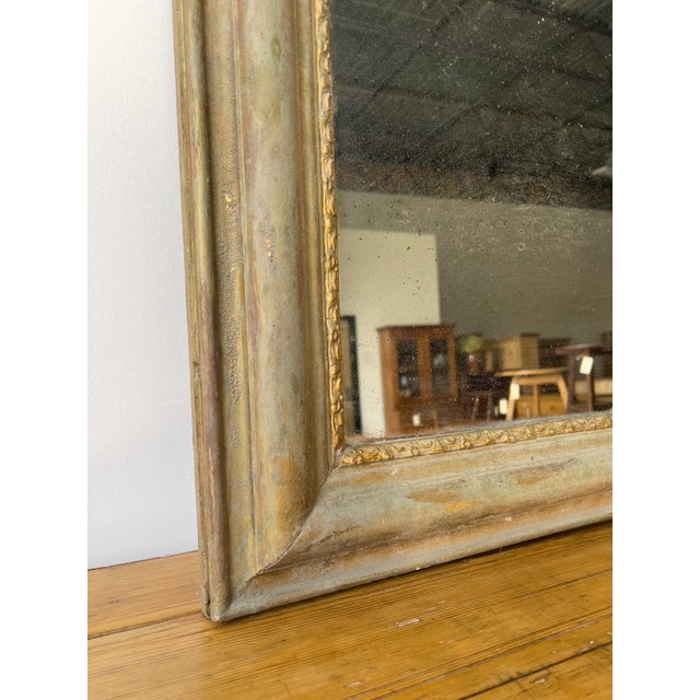This elegant antique Louis Philippe style mirror features a unique and beautiful light verdigris patina on its wide,...