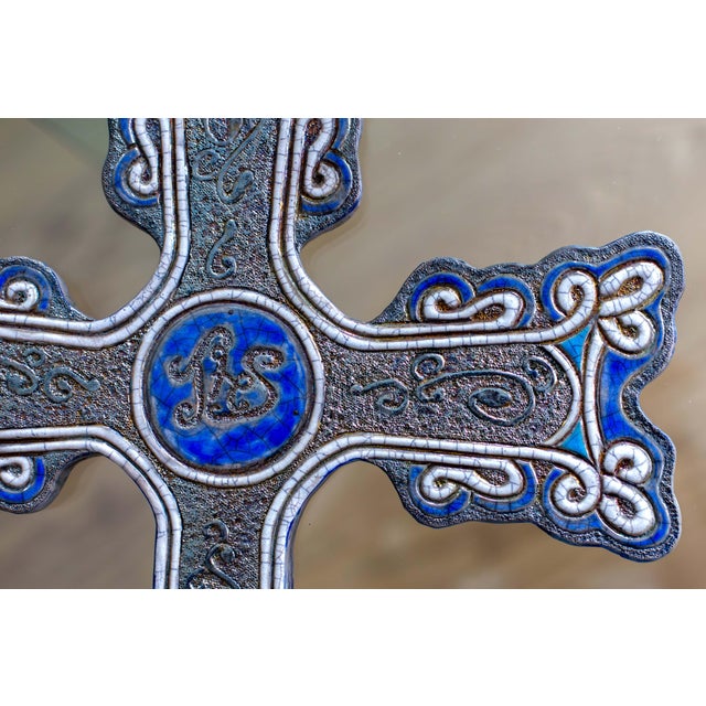"Jesus Hominum Salvator" is a unique Raku ceramic wall artwork, entirely hand-molded and decorated by artist Stefania...