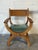 This "Kurul" armchair in style of Henning Kjærnulf features a dramatic curule X-frame construction and sculpted flat...