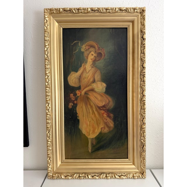 This charming antique oil on board depicts an elegant young woman dressed in a flowing pastel gown and wide-brimmed floral...