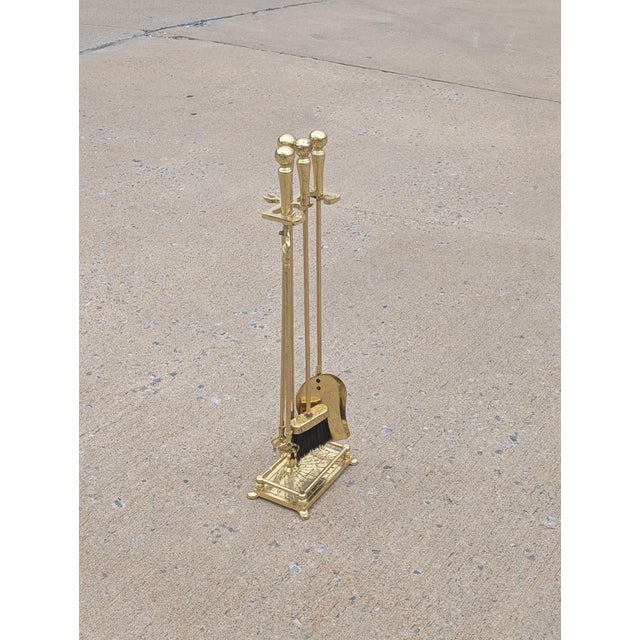 This exceptional vintage brass fireplace tools set brings timeless character and polished sophistication to the modern...