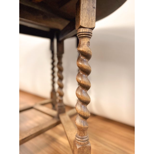 Late 19th century French gate leg table from Provence, handcrafted from solid oak. Featuring spool-turned legs, drop...