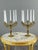 An elegant pair of gilt bronze candelabra with refined neoclassical-inspired decoration. Each piece features five finely...