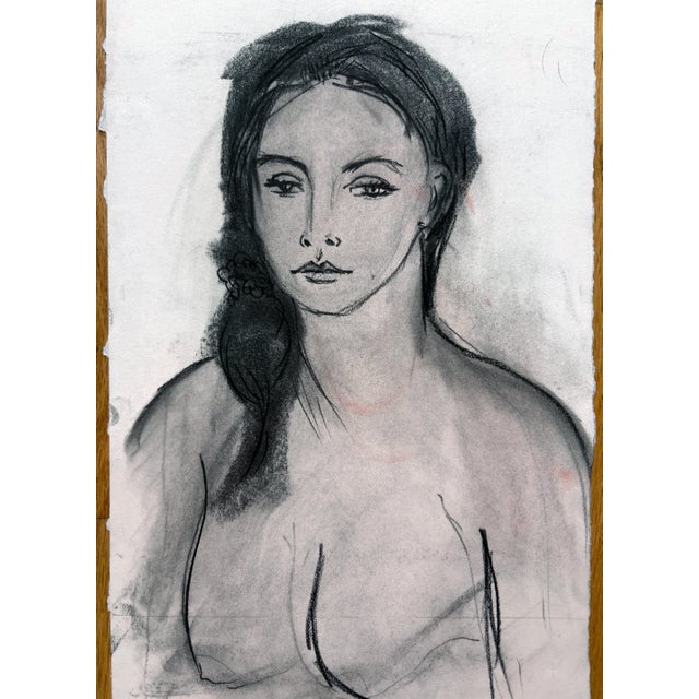 A beautiful and moody portrait drawing of a woman rendered in charcoal on paper. Soft tonal transitions and expressive...