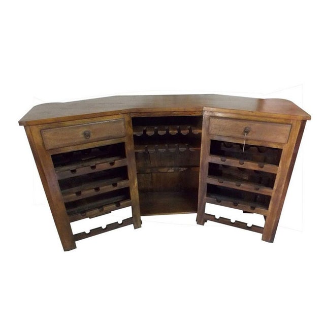 A substantial Mexican Colonial hacienda style bar featuring a richly patinated wood frame accented by hand-forged iron...