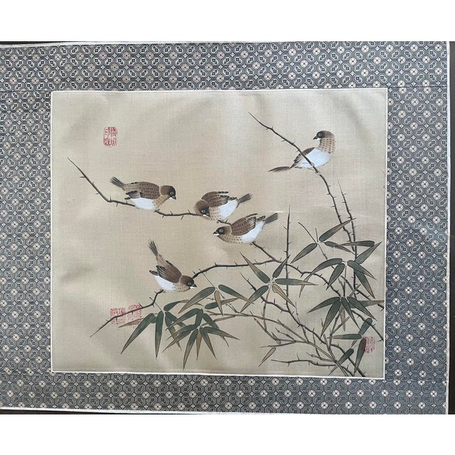 A wonderful painting of five birds on bamboo branches. Matted and in a warm toned, wooden frame. There four red seals in...
