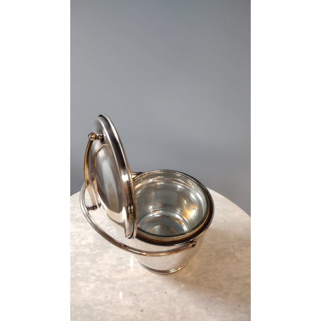 Elegant mid-century silver plate, glass lined ice bucket by Poole. Attractive silver plate, mild tarnish that can be...