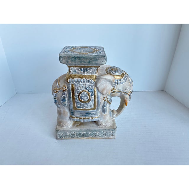 Vintage terracotta Asian elephant plant stand with muted gold and silver painted details, a beautiful juxtaposition of...