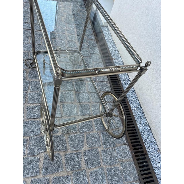 A very attractive silver-plated brass rolling serving cart from Jansen. This piece has an attribution mark, I am sure that...