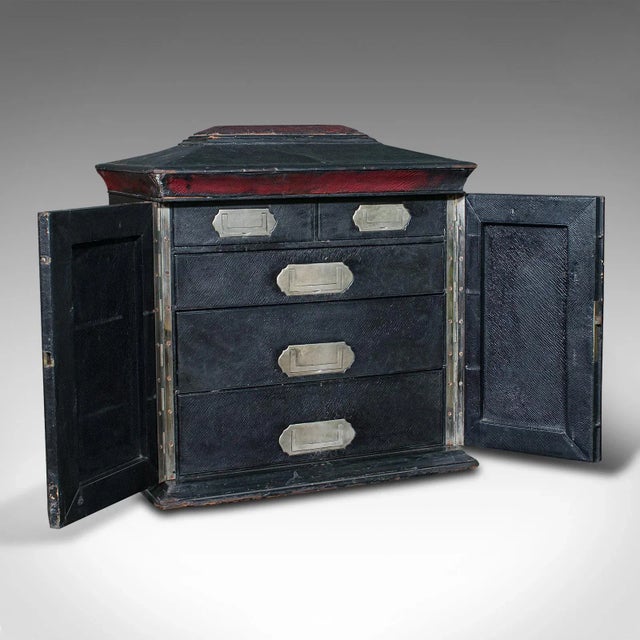 This is an antique correspondence box. An English, leather bound sarcophagus cabinet with secret compartment, attributed...