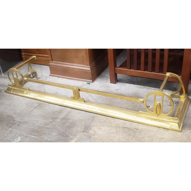 A 19th Century Edwardian Brass Fire Fender measuring 52.25" in width, 13" in depth and 8" high. Matching set of fireplace...