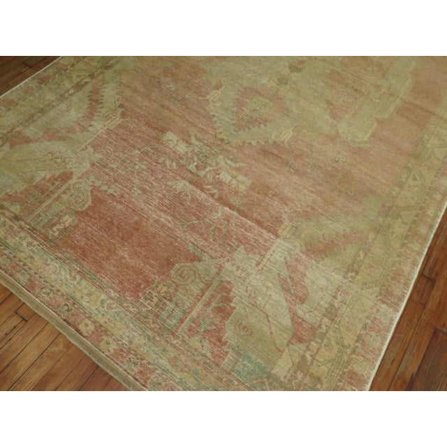 A vintage Turkish gallery rug with a central medallion on a pink field. accents in white and brown Measures: 6'3'' x 11'9''.