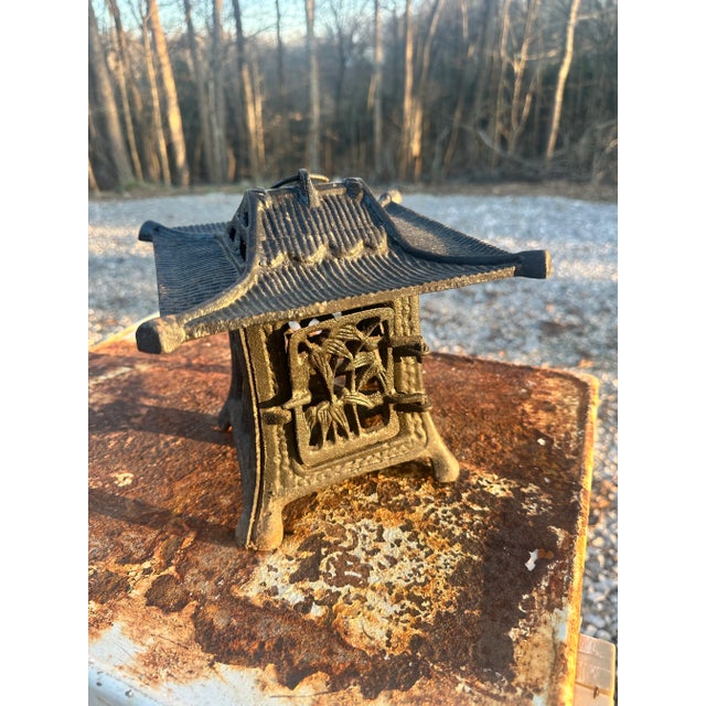 Cast iron pagoda garden lantern. Sits nicely on a table or can be hung. It has a rustic patina. very nice addition to any...