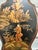 A decorative pair of Chinoiserie-style wall sconces featuring hand-painted scenic panels depicting figures in a stylized...