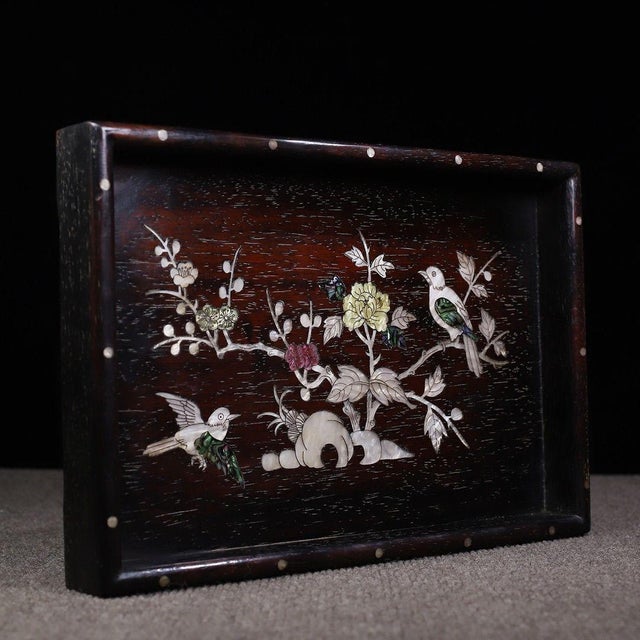 This is a beautifully crafted rectangular wooden tray featuring intricate mother-of-pearl (nacre) inlay work. Crafted from...