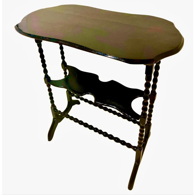 19th century English accent table with a curved top, bobbin turned leg and a lower tier. The wood is elm or poplar....