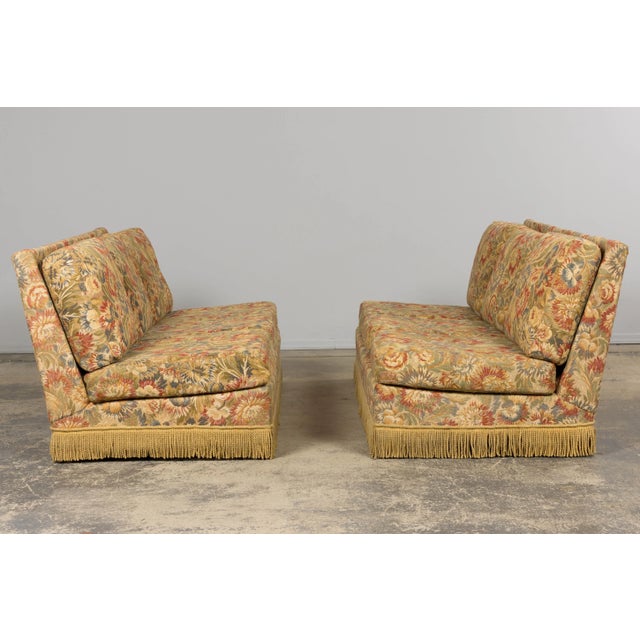 A monumental pair of vintage French sofas, sourced in Provence. Upholstered in the original floral tapestry fabric woven...