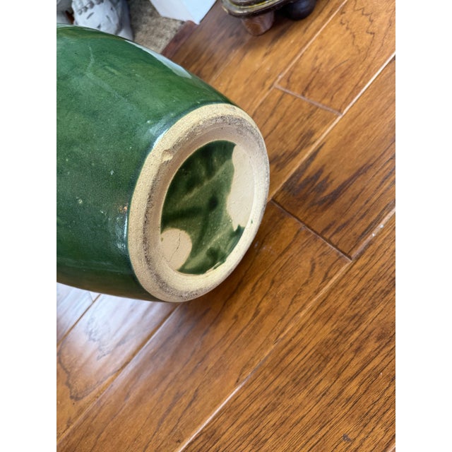 This heavy art pottery urn is glazed lovely shades of teal, olive and white.