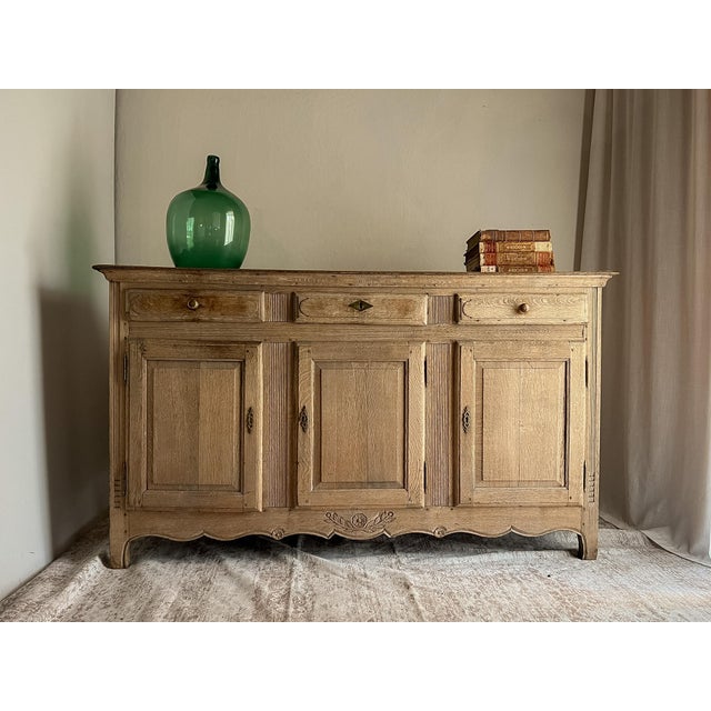 Rich with history and authentic provincial character, this antique French oak buffet dates to the late 19th century and...