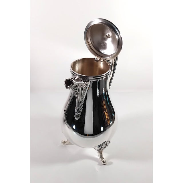 Pompadour coffee pot. A reinterpretation of the Louis XV style: the knob, spout, handle, and legs feature a sophisticated,...