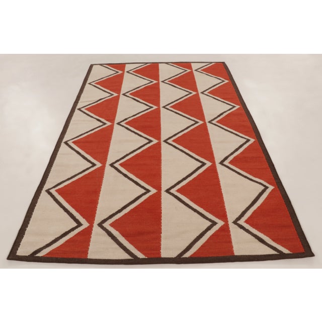 This 6x9 contemporary Scandinavian flatweave is handwoven in wool and features a bold rhythmic zigzag of interlocking...
