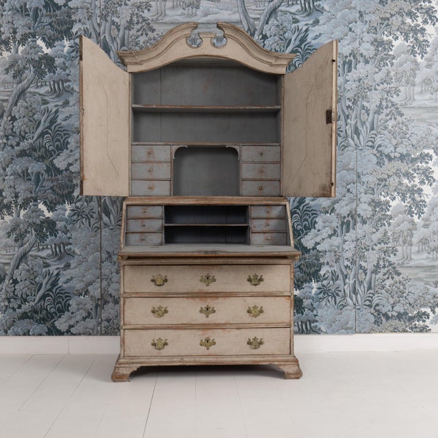 A Swedish slant-front secretary with library from the Gustavian period in two parts, circa 1790. A pediment top and upper...