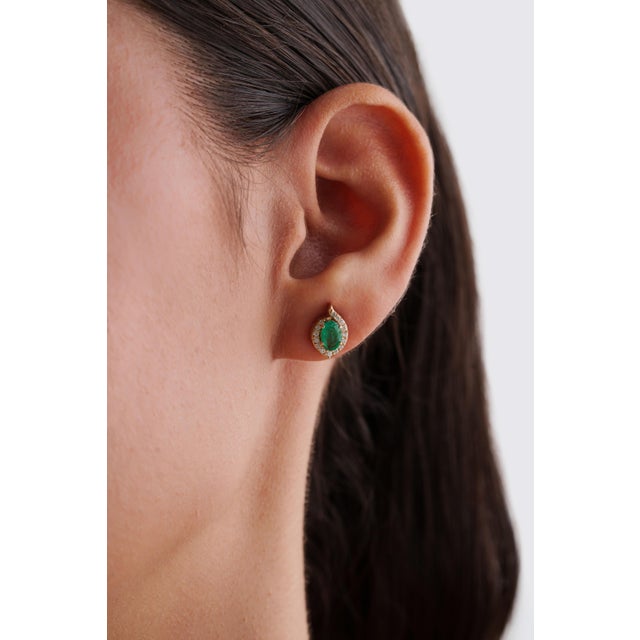 These elegant stud earrings feature 0.74 carats of oval-cut emerald set in 14K yellow gold. Each emerald measures 6 × 4 mm...
