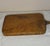 An exceptional and highly tactile antique American country farmhouse cutting board, carved from a single, substantial...