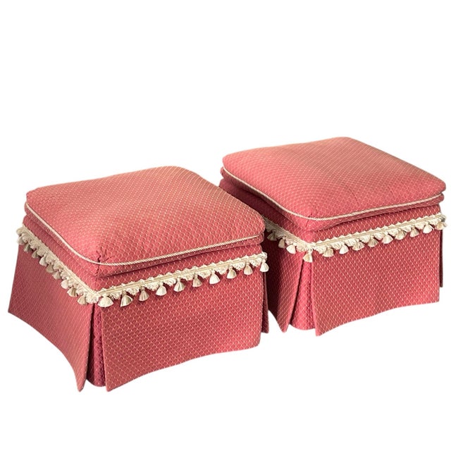 A matching pair of custom upholstered square ottomans with a tailored, traditional look. These ottomans features a thick,...