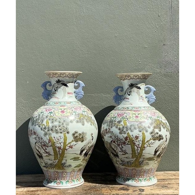 This magnificent pair of large-scale porcelain vases celebrates the timeless elegance of traditional Chinese artistry....