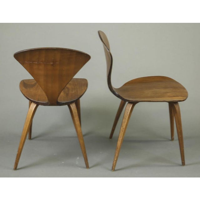 A pair of iconic 1960's Cherner Side Chairs by Norman Cherner for Plycraft. The chairs were crafted using molded laminated...