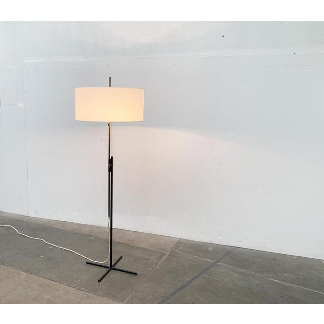 Rare mid century standing lamp from Kaiser glow with a special minimalist foot. The special detail of this lamp is the...